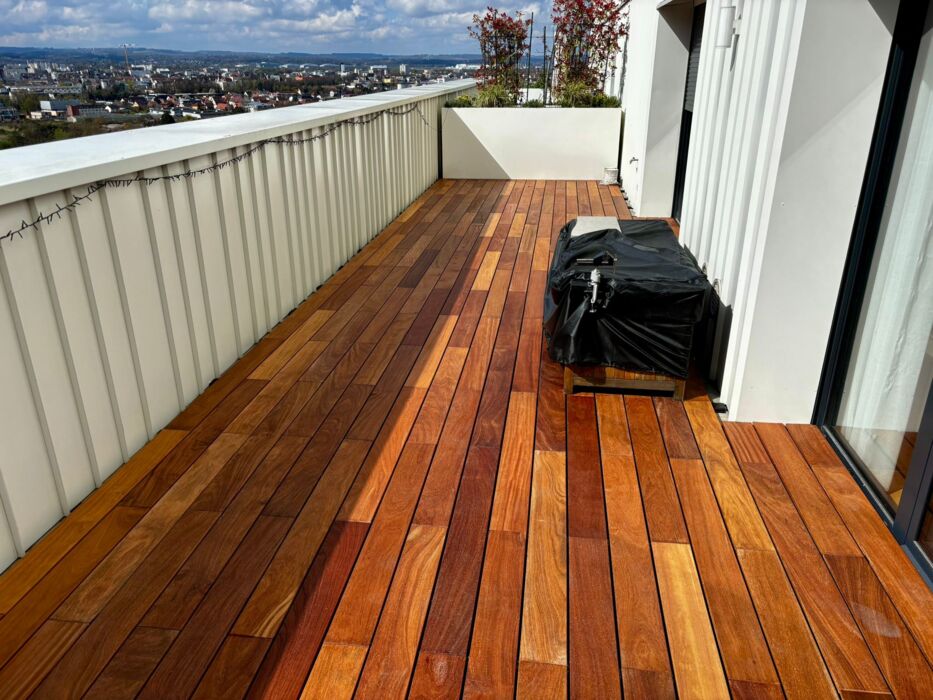 Premium Ipé hardwood decking installed on a 10th-floor balcony using invisible fixing clips and spacers for a seamless finish.
