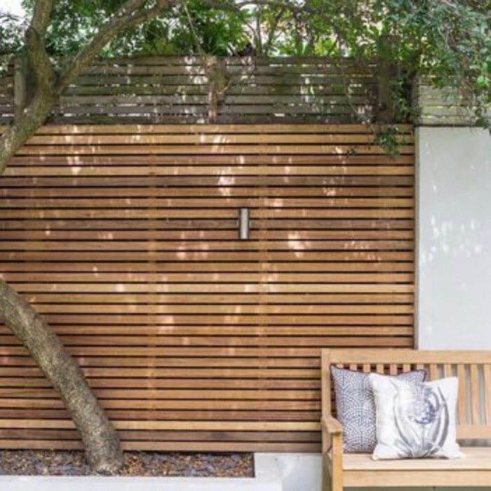 Modern horizontal Ipé hardwood slat fencing with hidden fixings for privacy and a high-end architectural look