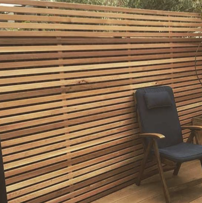 Sleek Ipé hardwood slat fencing installed with an invisible clip system and no visible screws.